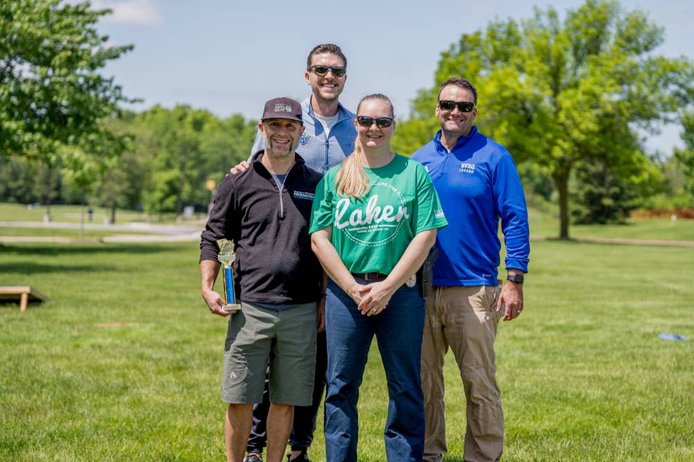 The top two teams pose for a group photo with trophies